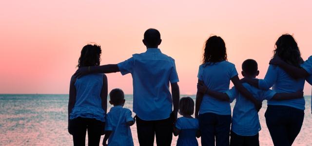 Family on the beach looking at sunset